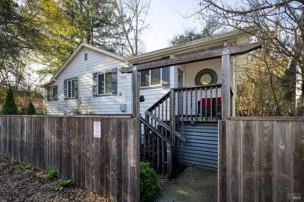 a view of a house with wooden fence