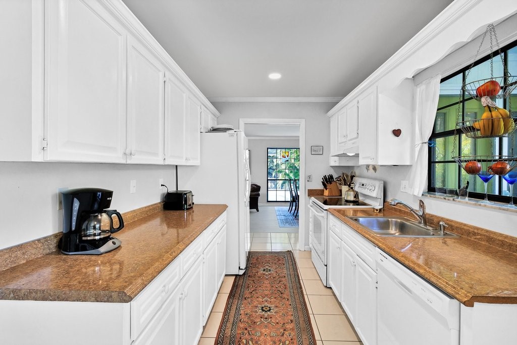 549 Layport Drive Sebastian, FL 32958 - Photo 14 of 35 a kitchen with sink a stove and cabinets