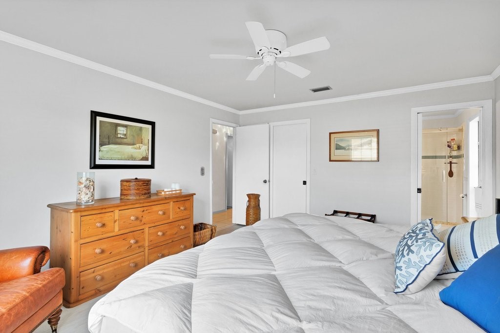 549 Layport Drive Sebastian, FL 32958 - Photo 18 of 35 a bedroom with a bed and a chandelier