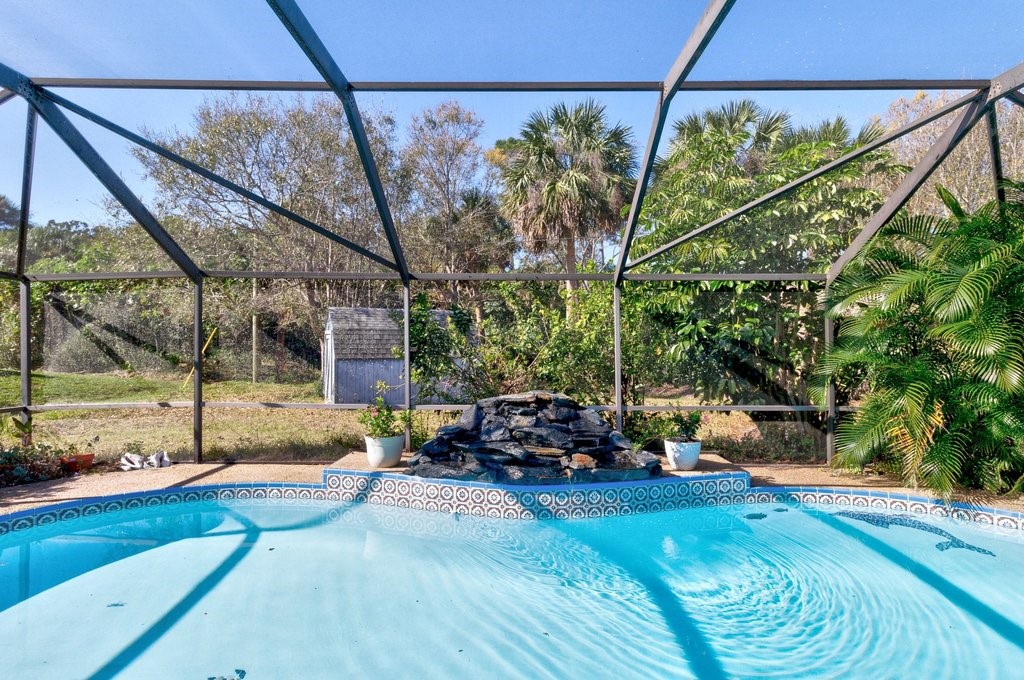 549 Layport Drive Sebastian, FL 32958 - Photo 22 of 35 a view of a backyard with couches and table under an umbrella