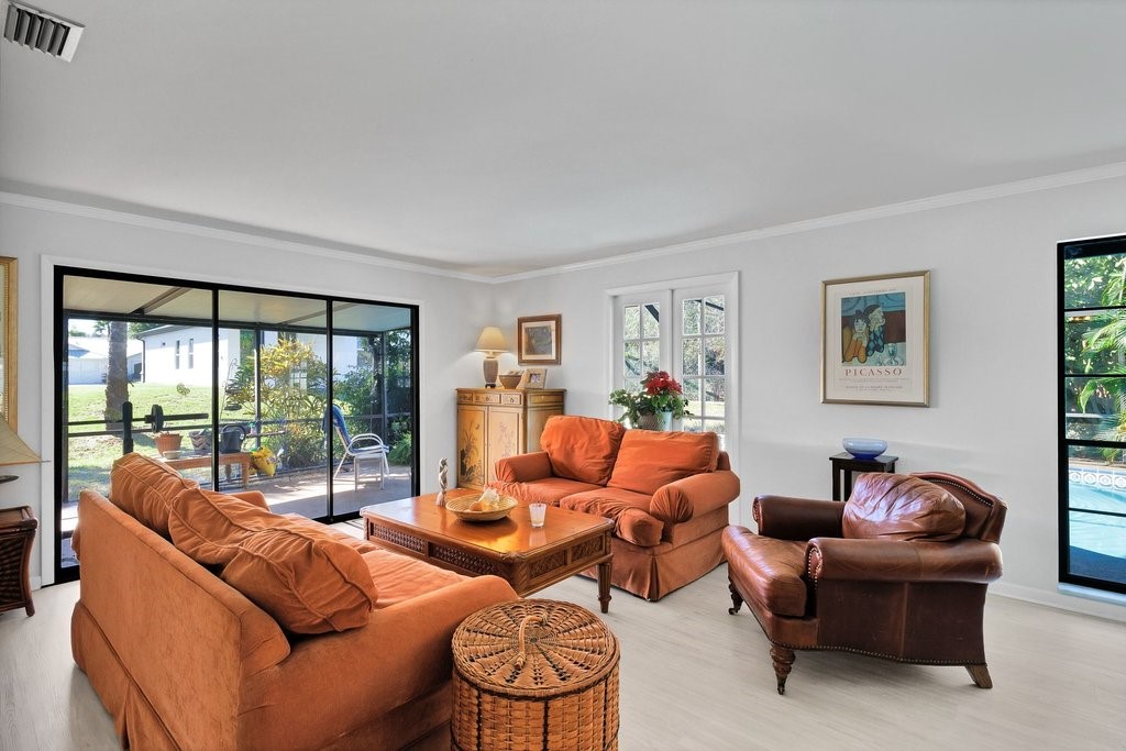 549 Layport Drive Sebastian, FL 32958 - Photo 7 of 35 a living room with furniture and a floor to ceiling window
