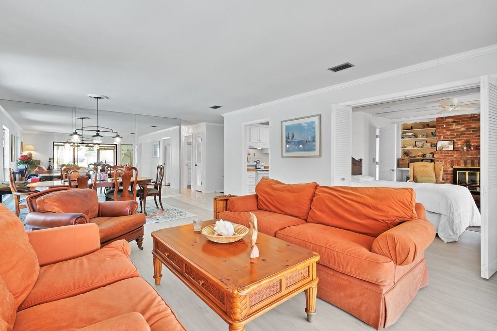 549 Layport Drive Sebastian, FL 32958 - Photo 8 of 35 a living room with furniture a chandelier and a dining table