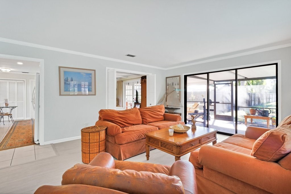 549 Layport Drive Sebastian, FL 32958 - Photo 9 of 35 a living room with furniture and a floor to ceiling window