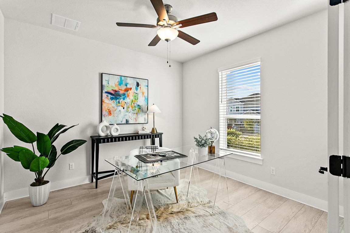 1265 Hazy Hills Loop Dripping Springs, TX 78620 - Photo 11 of 40 a living room with furniture a potted plant and a window