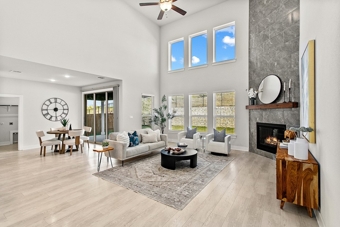 1265 Hazy Hills Loop Dripping Springs, TX 78620 - Photo 12 of 40 a living room with furniture wooden floor and a fireplace