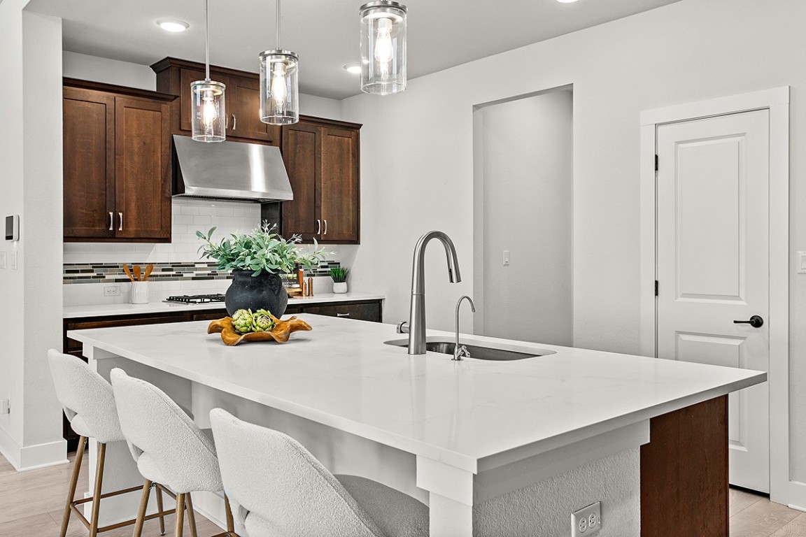1265 Hazy Hills Loop Dripping Springs, TX 78620 - Photo 14 of 40 a kitchen with a sink a counter space and cabinets