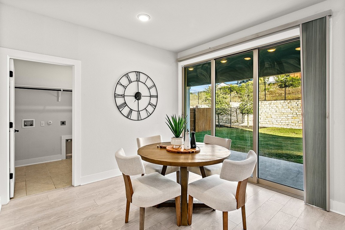 1265 Hazy Hills Loop Dripping Springs, TX 78620 - Photo 17 of 40 a view of a dining room with furniture window and wooden floor