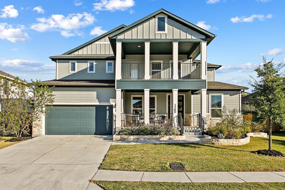 1265 Hazy Hills Loop Dripping Springs, TX 78620 - Photo 2 of 40 a front view of a house with a yard