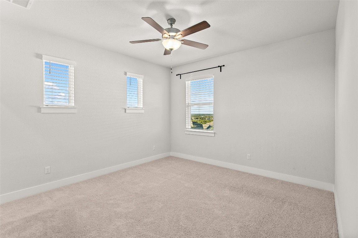 1265 Hazy Hills Loop Dripping Springs, TX 78620 - Photo 23 of 40 an empty room with a window and a ceiling fan