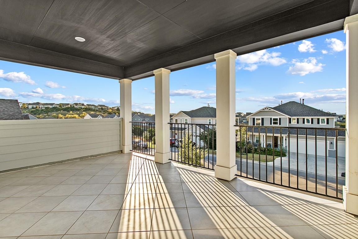 1265 Hazy Hills Loop Dripping Springs, TX 78620 - Photo 26 of 40 a view of a balcony with lake view and wooden floor