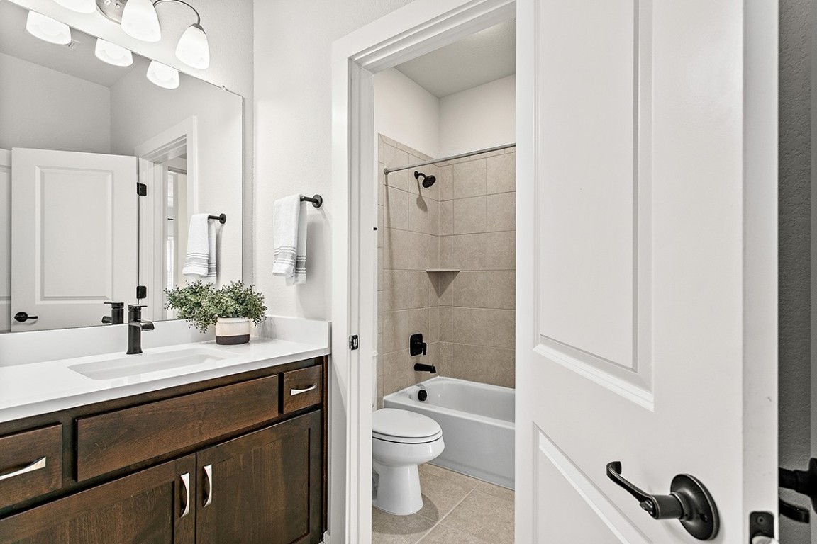 1265 Hazy Hills Loop Dripping Springs, TX 78620 - Photo 27 of 40 a bathroom with a double vanity sink toilet and shower