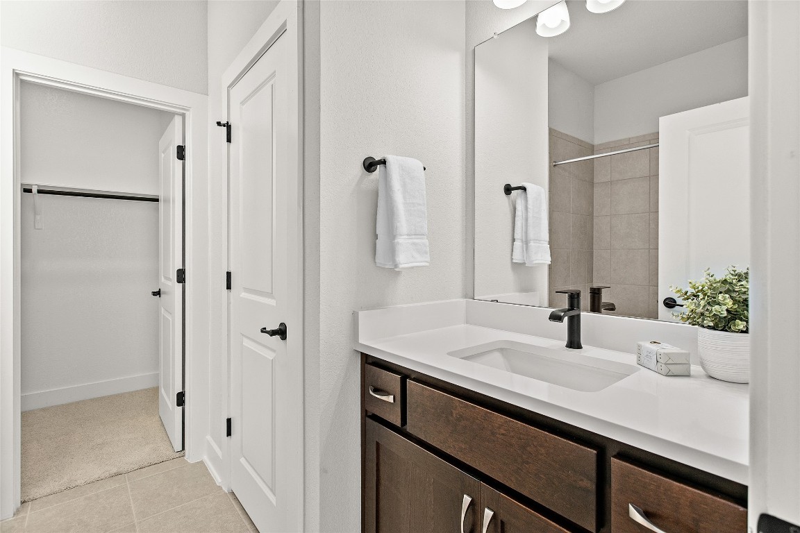 1265 Hazy Hills Loop Dripping Springs, TX 78620 - Photo 32 of 40 a bathroom with a sink and a mirror