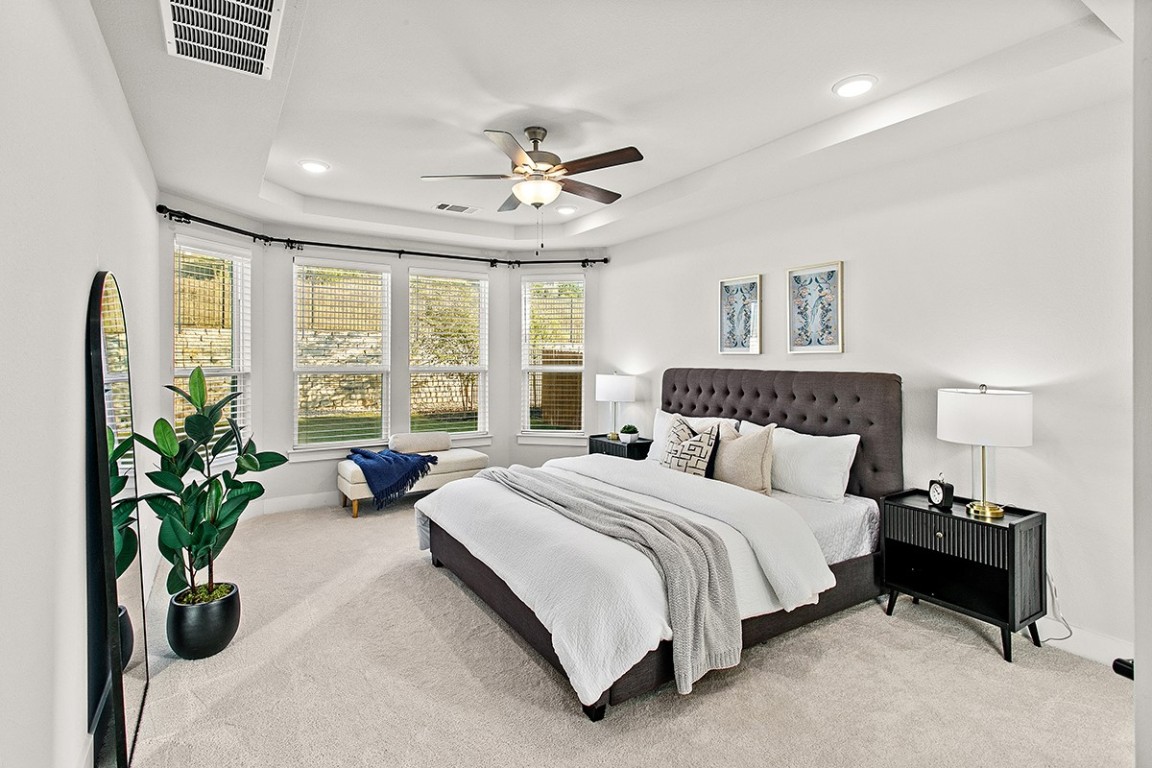 1265 Hazy Hills Loop Dripping Springs, TX 78620 - Photo 7 of 40 a bedroom with bed and a large window