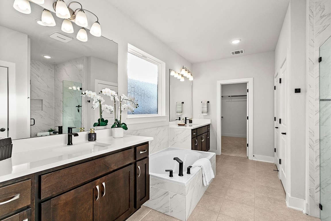 1265 Hazy Hills Loop Dripping Springs, TX 78620 - Photo 8 of 40 a spacious bathroom with a double vanity sink mirror and double