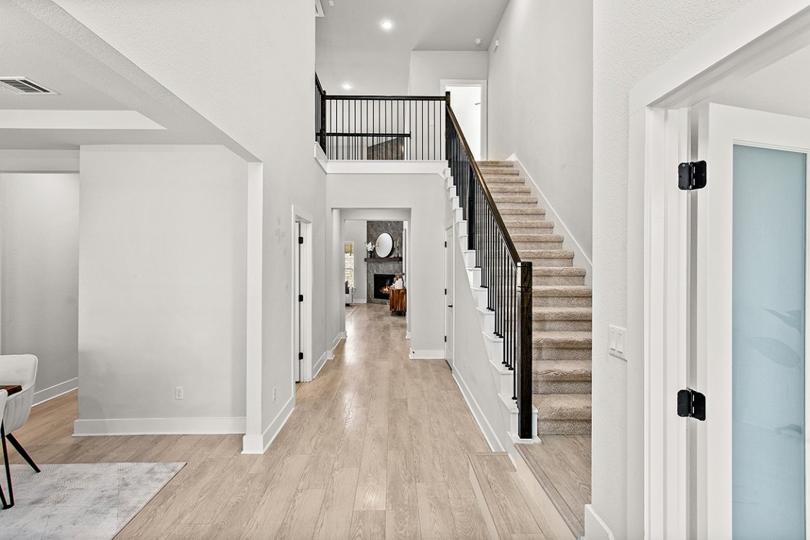 1265 Hazy Hills Loop Dripping Springs, TX 78620 - Photo 9 of 40 a view of a hallway with wooden floor and entryway