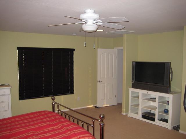 3247 East Tyson Street Gilbert, AZ 85295 - Photo 22 of 34 a bedroom with a bed and a flat tv screen on dresser