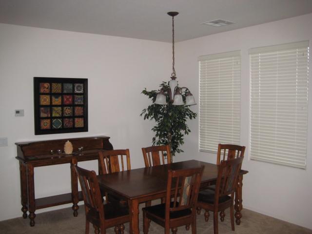 3247 East Tyson Street Gilbert, AZ 85295 - Photo 3 of 34 a view of a dining room with furniture and chandelier