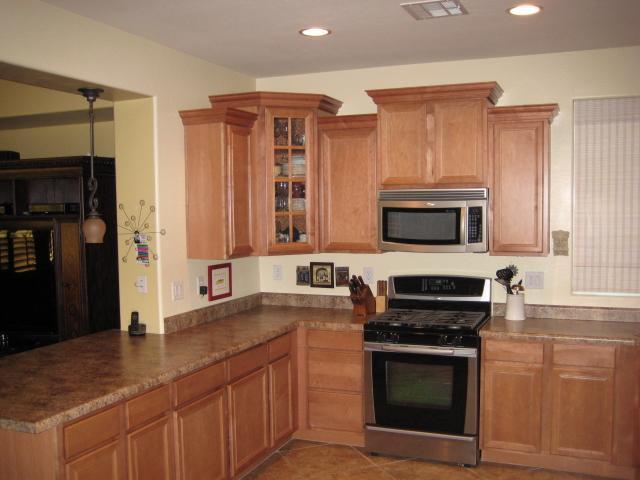 3247 East Tyson Street Gilbert, AZ 85295 - Photo 4 of 34 a kitchen with stainless steel appliances granite countertop a stove a sink and a microwave