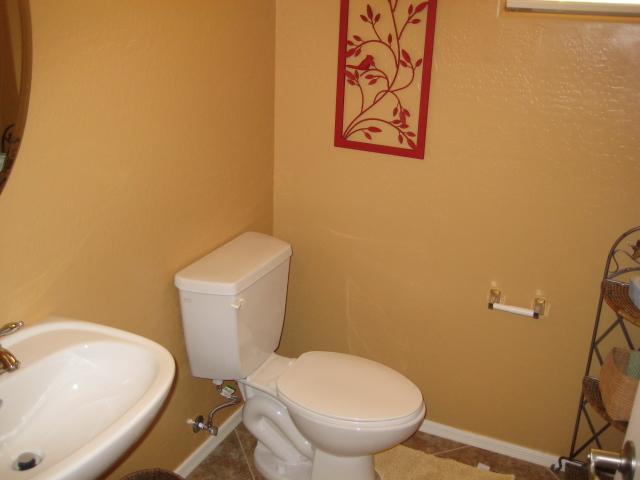 3247 East Tyson Street Gilbert, AZ 85295 - Photo 10 of 34 a white toilet sitting next to a white wall