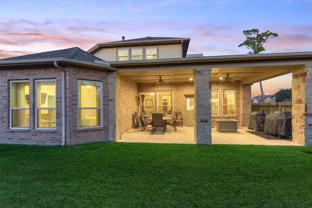 a view of a house with backyard and porch