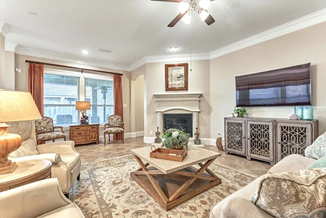 a living room with furniture large window and a fireplace