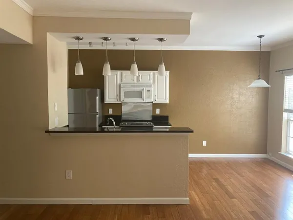 a view of a room with wooden floor