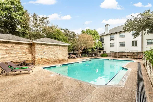 a view of a house with swimming pool and sitting area