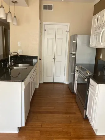 a kitchen with a sink stove and refrigerator