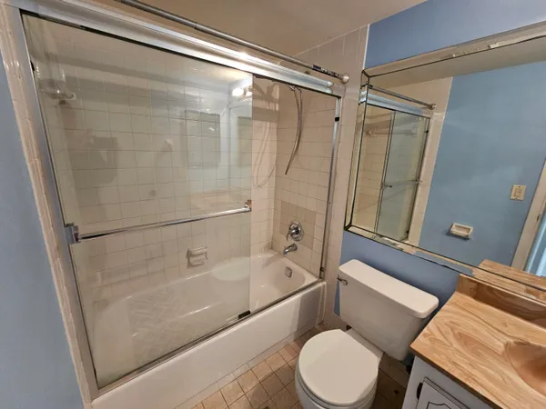 a bathroom with a toilet and a shower