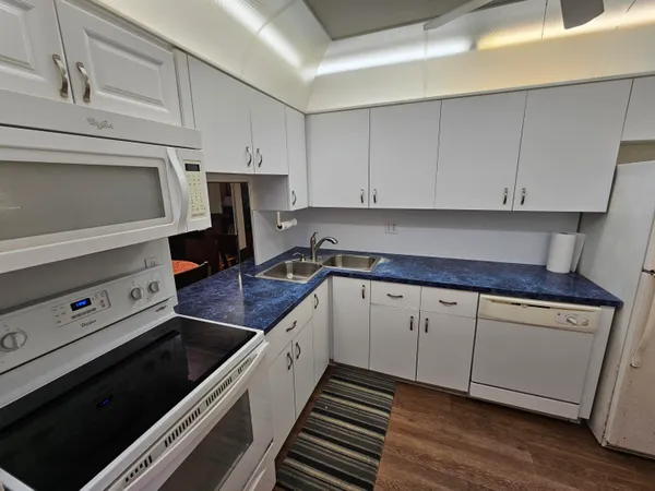 a kitchen with granite countertop cabinets and steel stainless steel appliances