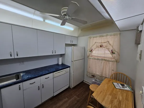 a kitchen with refrigerator and cabinets