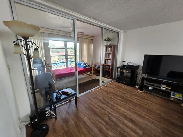 a bedroom with furniture and a flat screen tv
