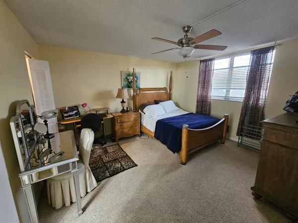 a bedroom with bed and window