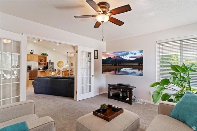 1924 North 2000th Street East Layton, UT 84040 - Photo 18 of 41 Living area with carpet, a ceiling fan, lofted ceiling, and french doors