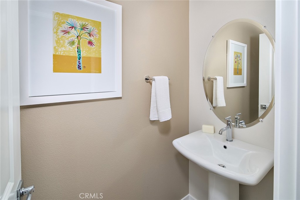 5911 Rockport Road Eastvale, CA 92880 - Photo 8 of 39 a bathroom with a sink and a mirror