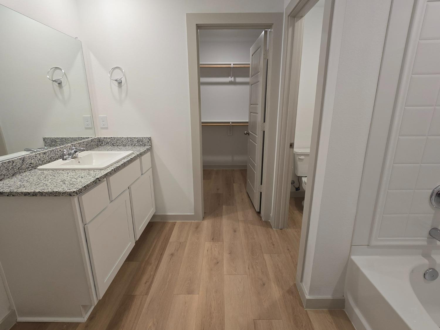 7425 8th Street Lubbock, TX 79416 - Photo 11 of 25 a bathroom with a sink and a mirror