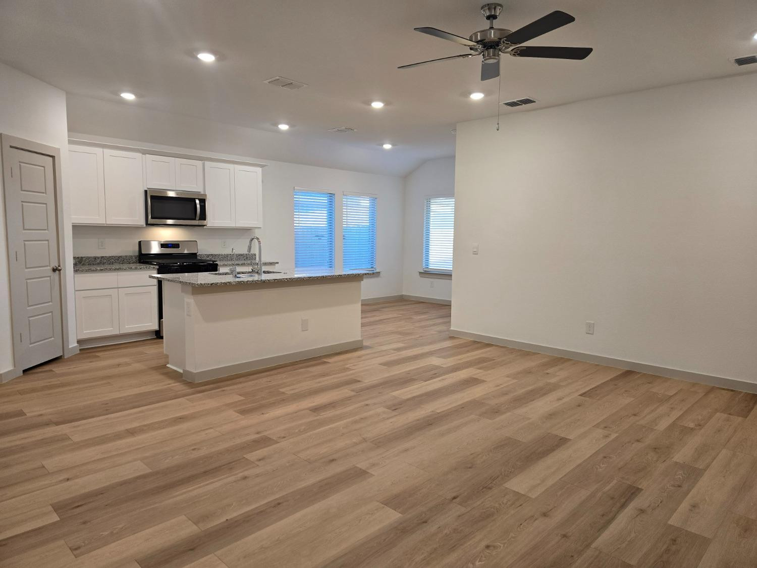 7425 8th Street Lubbock, TX 79416 - Photo 2 of 25 a view of kitchen with kitchen island stainless steel appliances a sink and cabinets