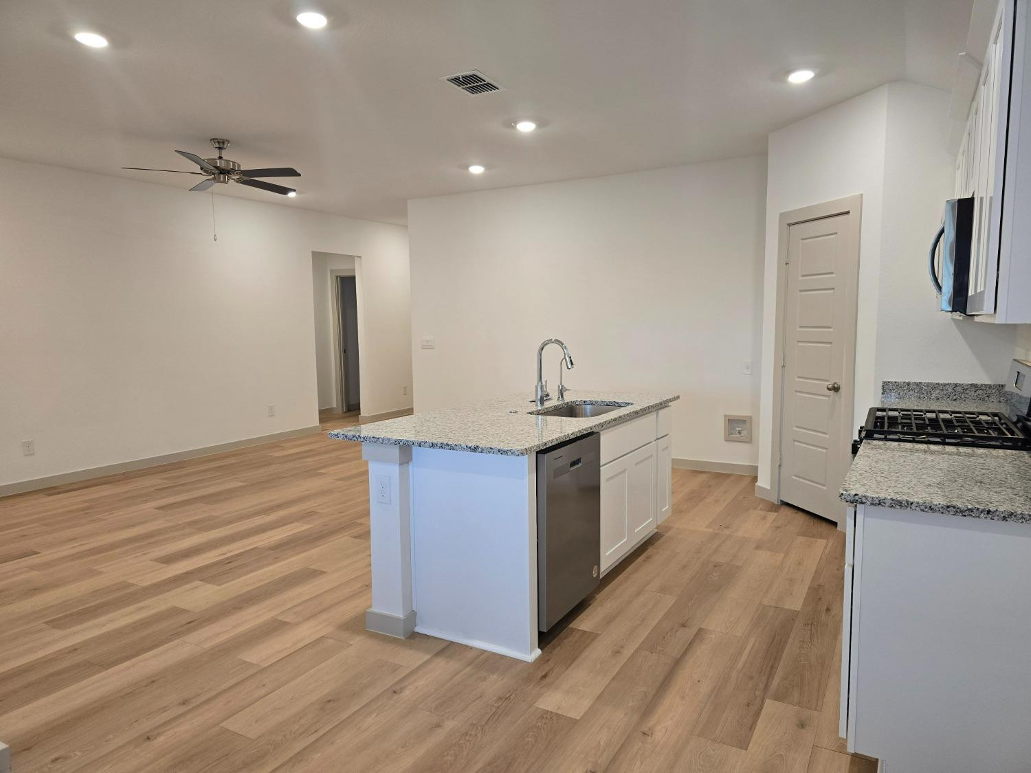7425 8th Street Lubbock, TX 79416 - Photo 4 of 25 a kitchen with stainless steel appliances granite countertop a stove and a refrigerator