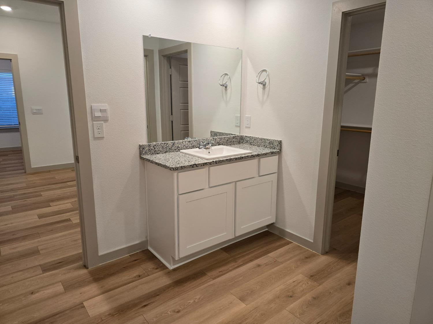 7425 8th Street Lubbock, TX 79416 - Photo 10 of 25 a bathroom with a sink and mirror