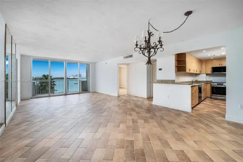 a view of a kitchen with a sink and a refrigerator