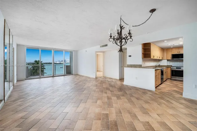 a view of a kitchen with a sink and a refrigerator