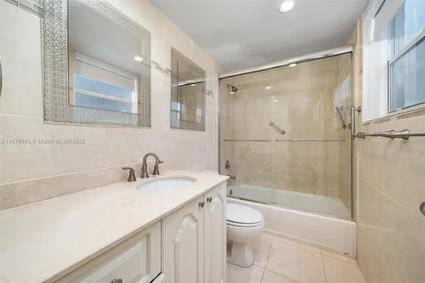 a bathroom with a sink mirror toilet and bathtub