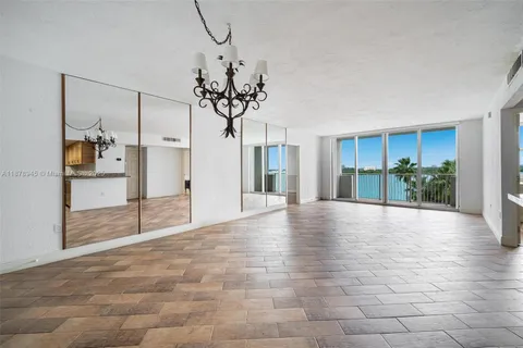 a view of a room with a chandelier and fireplace