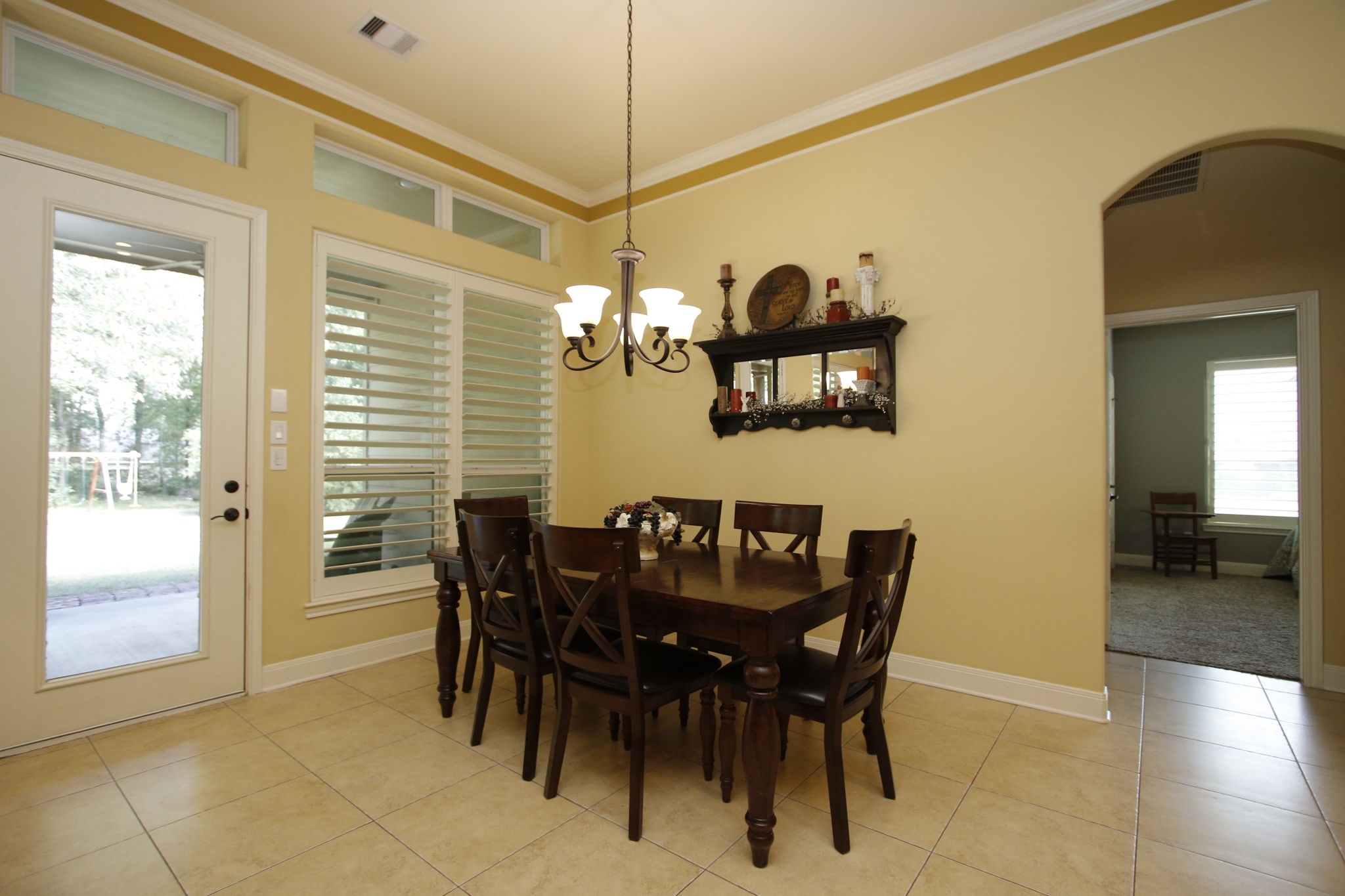 1547 Ruby Drive Willis, TX 77378 - Photo 18 of 48 a view of a dining room and livingroom with furniture wooden floor a chandelier