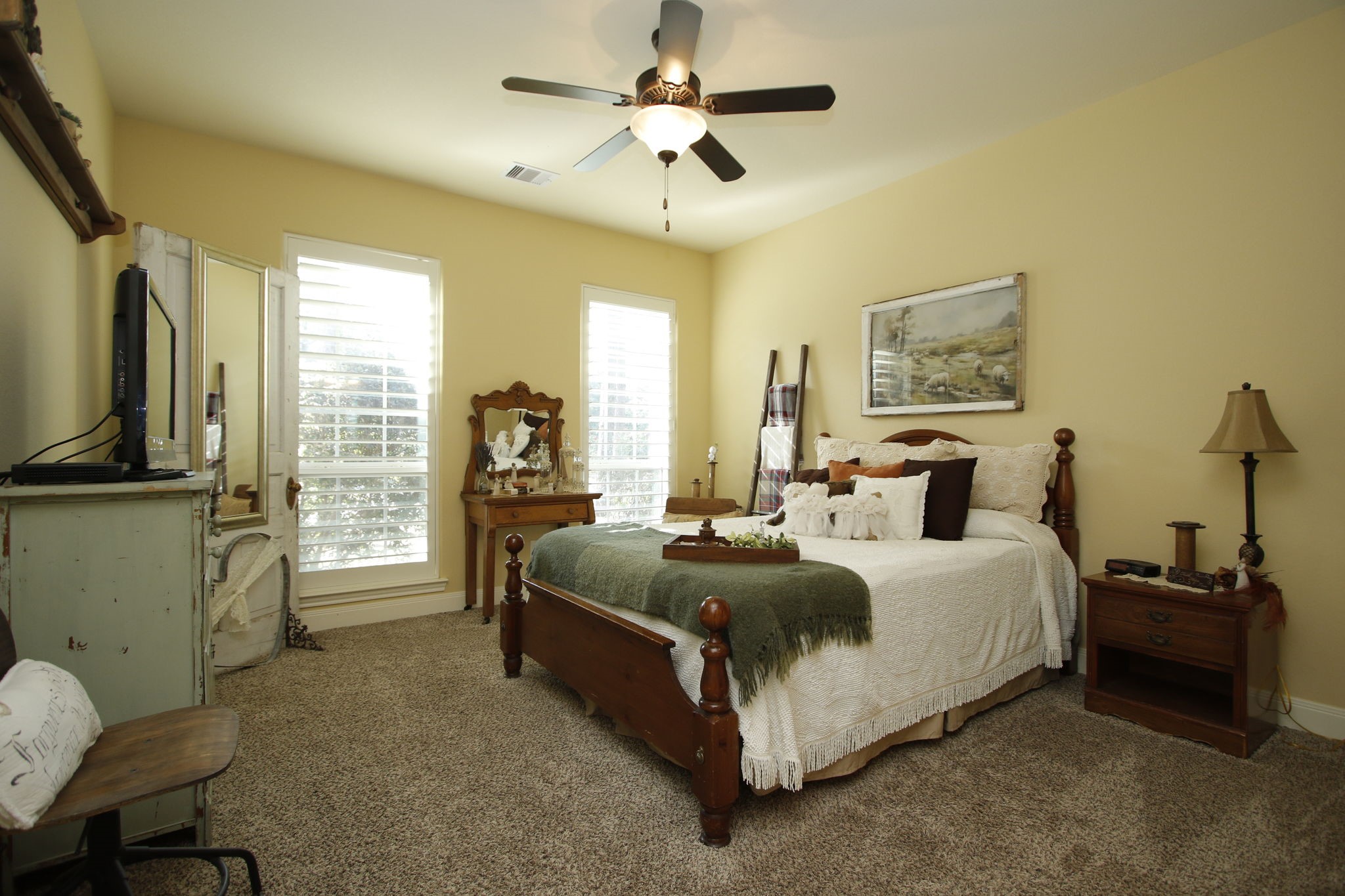 1547 Ruby Drive Willis, TX 77378 - Photo 20 of 48 a spacious bedroom with a bed a couch and a chandelier