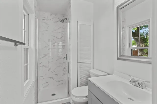 a bathroom with a sink toilet and shower