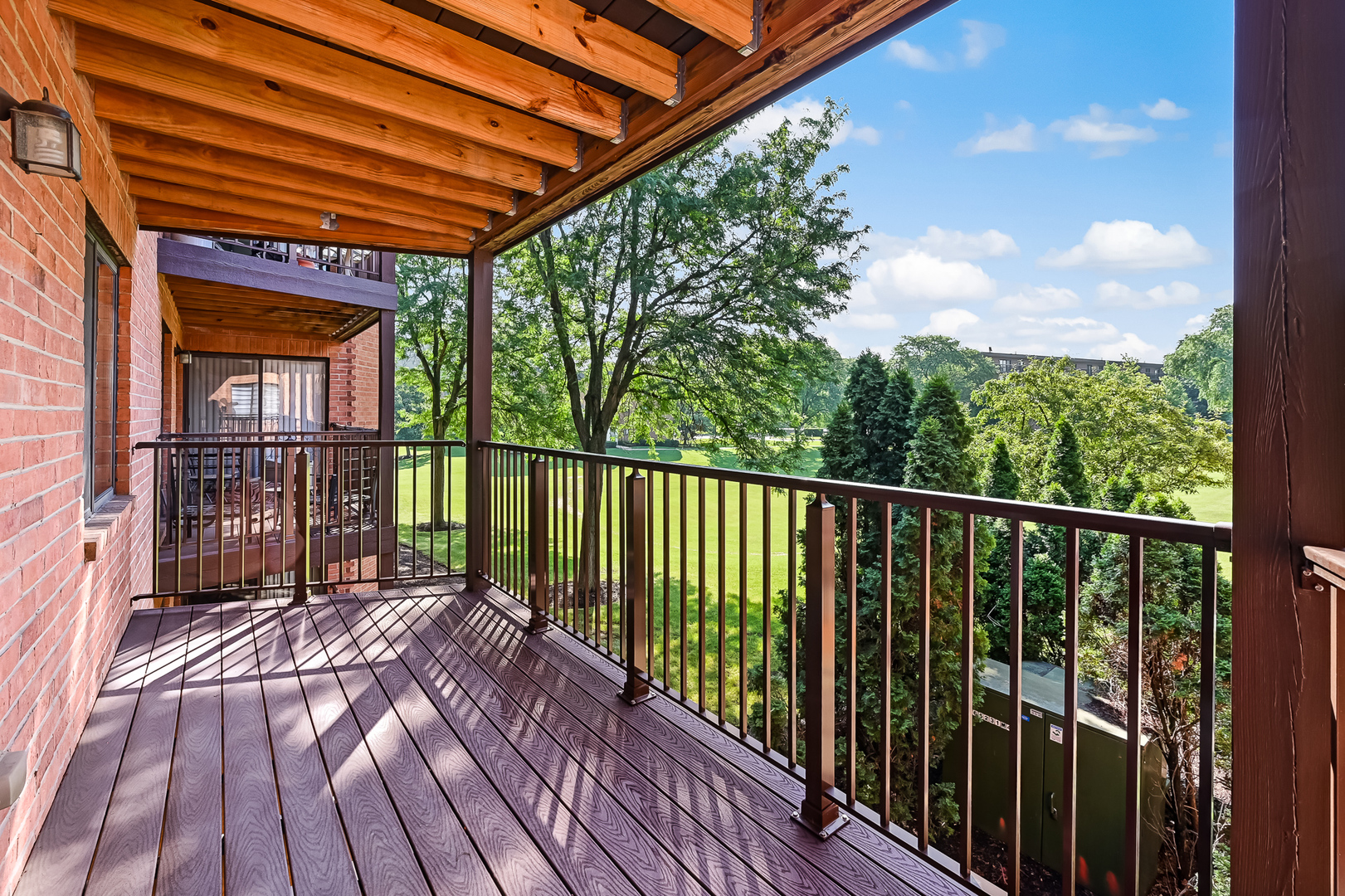 6401 Clarendon Hills Road, Unit 207 Willowbrook, IL 60527 - Photo 11 of 18 a view of balcony with wooden floor and fence