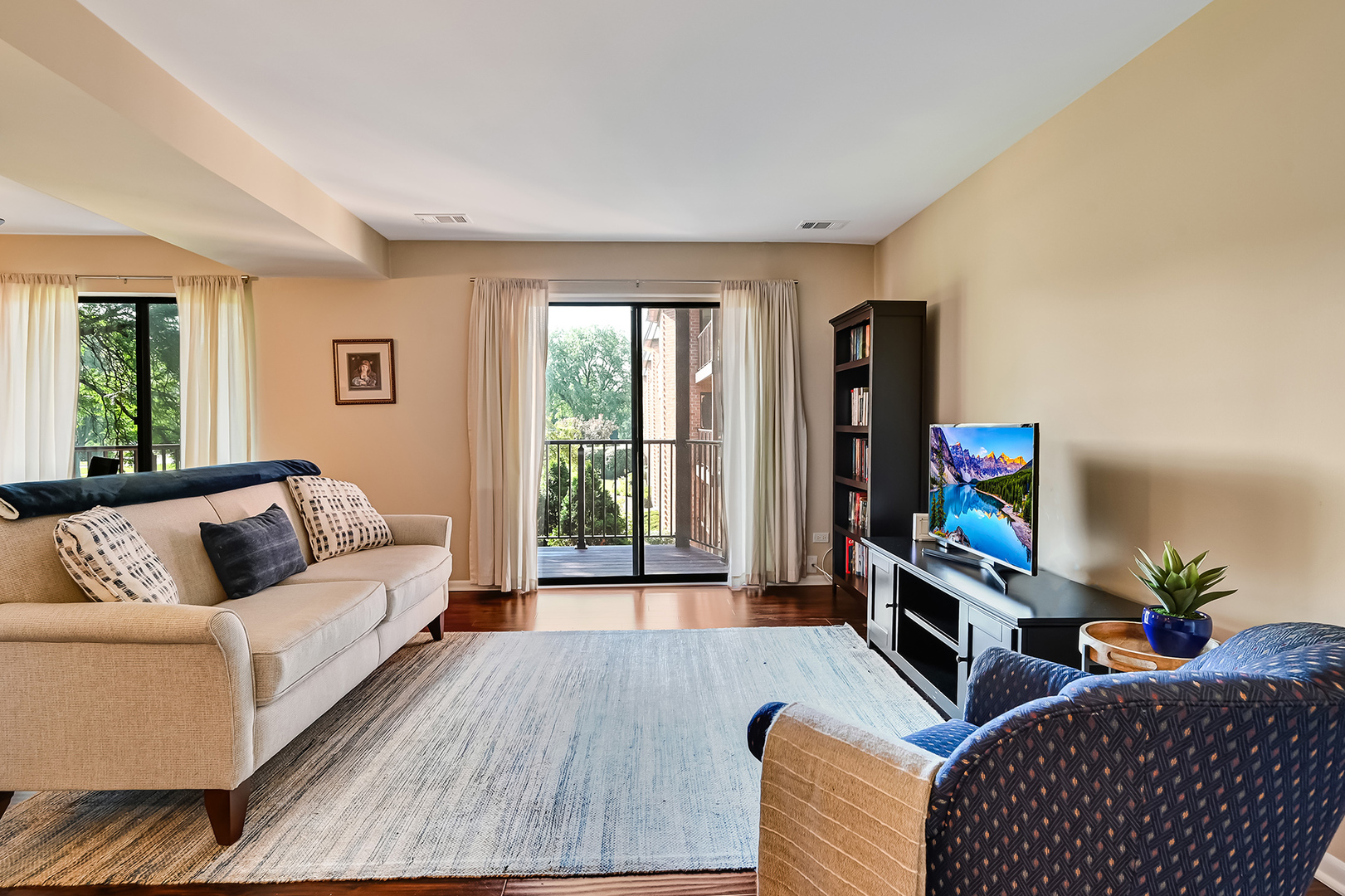 6401 Clarendon Hills Road, Unit 207 Willowbrook, IL 60527 - Photo 2 of 18 a living room with furniture a flat screen tv and a window