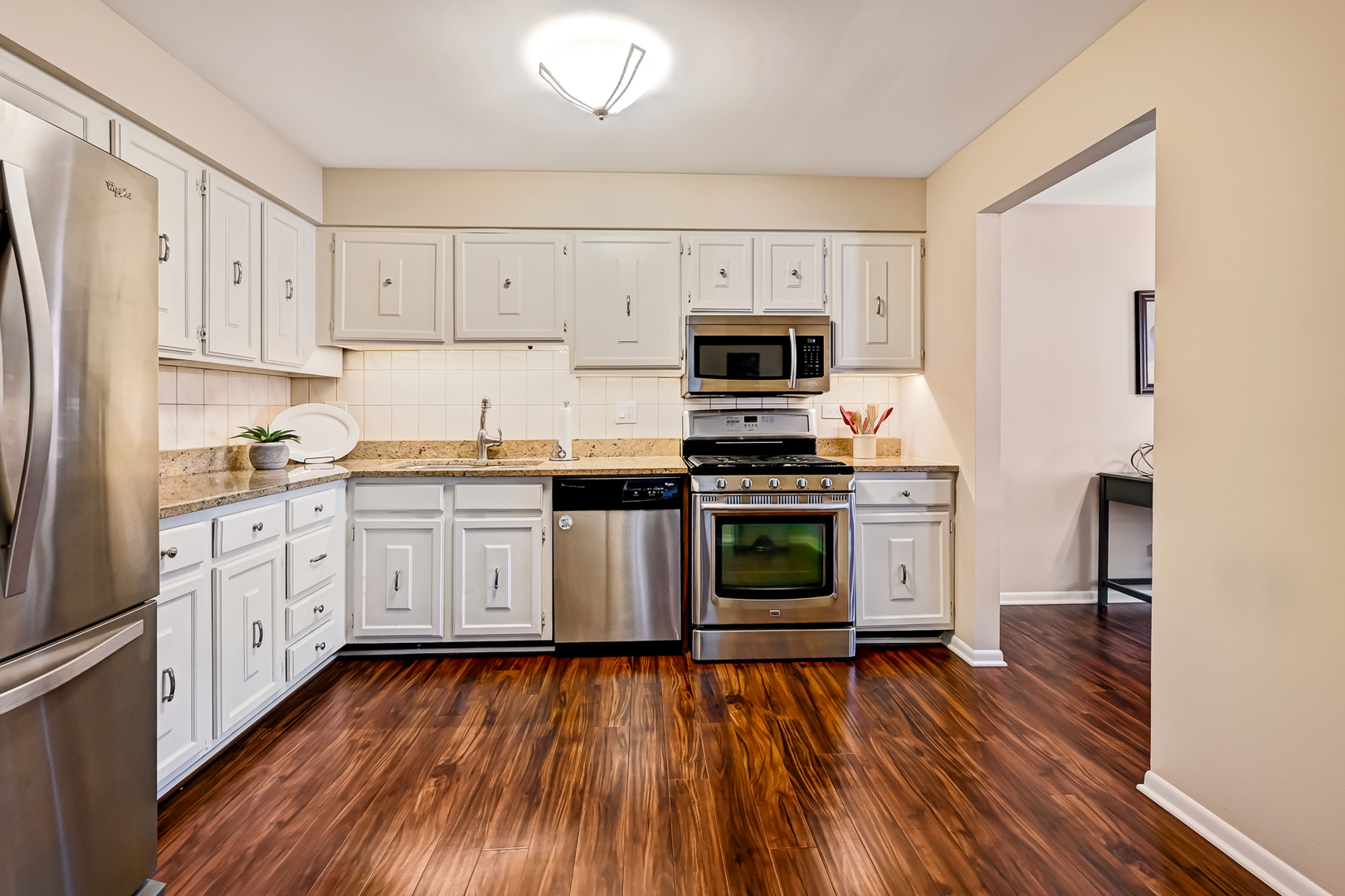 6401 Clarendon Hills Road, Unit 207 Willowbrook, IL 60527 - Photo 5 of 18 a kitchen with stainless steel appliances a white stove top oven a sink and a refrigerator