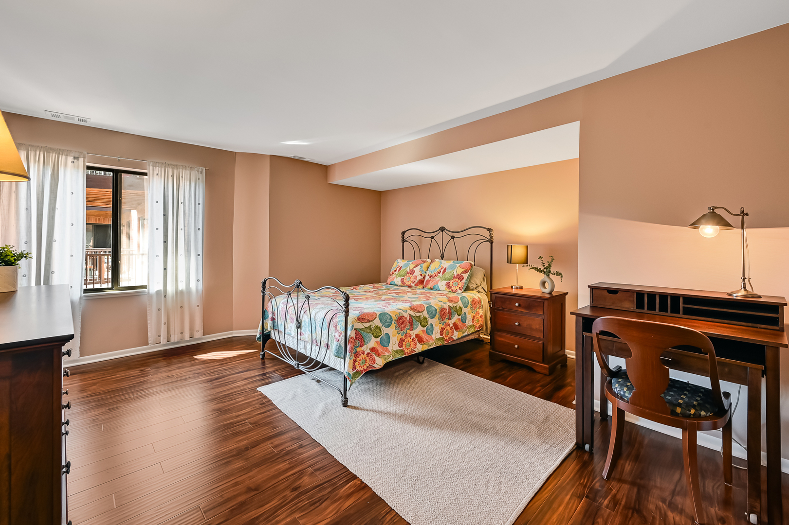 6401 Clarendon Hills Road, Unit 207 Willowbrook, IL 60527 - Photo 7 of 18 a bedroom with a bed a table and wooden floor